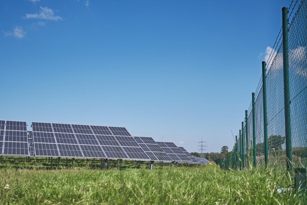 solar-panels-on-green-grass-field-under-blue-sky-during-daytime-czqpp2rrjd4
